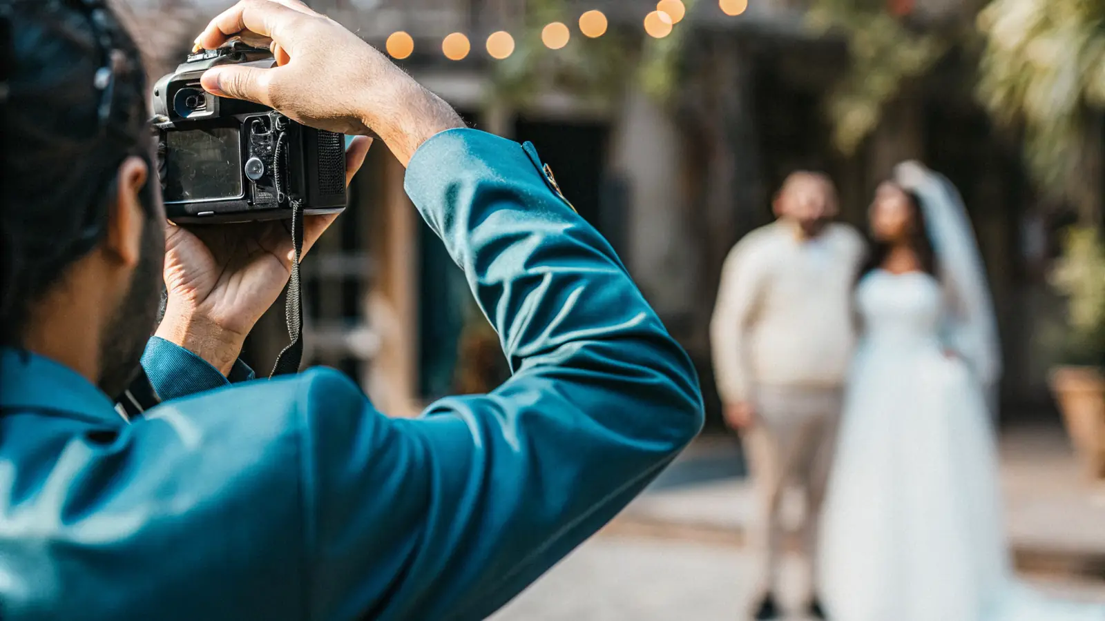 a wedding photographer capturing a couple in soft natural light